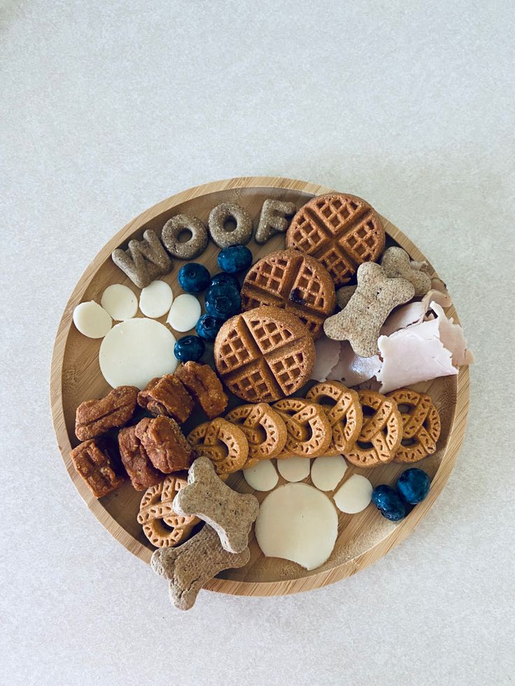 a wooden bowl filled with different types of dog treats