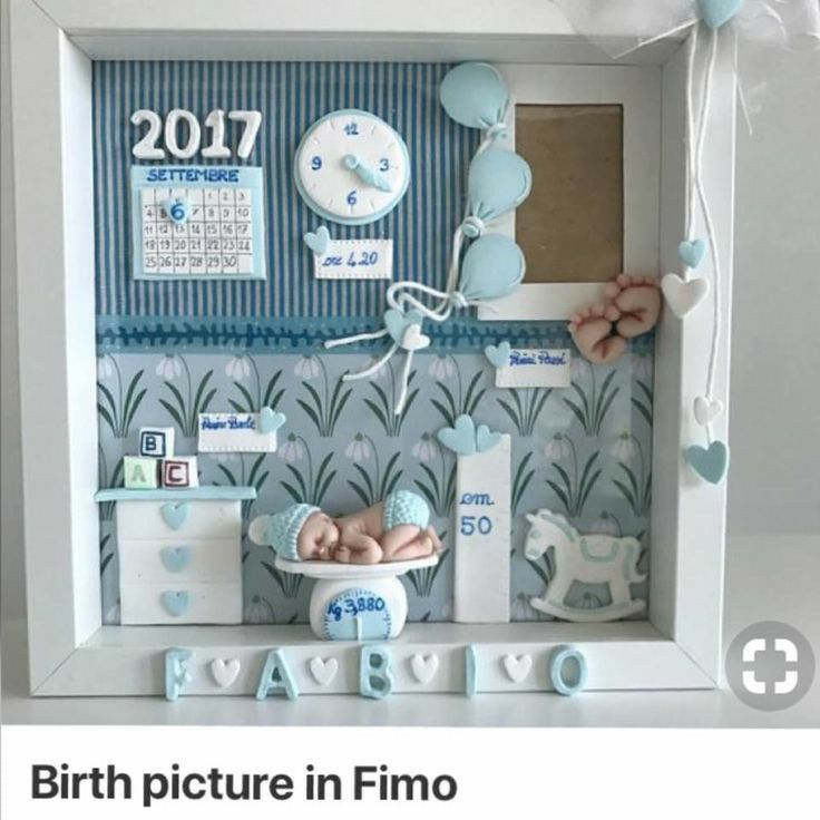 a baby's photo frame is decorated with blue and white items, including a rocking horse