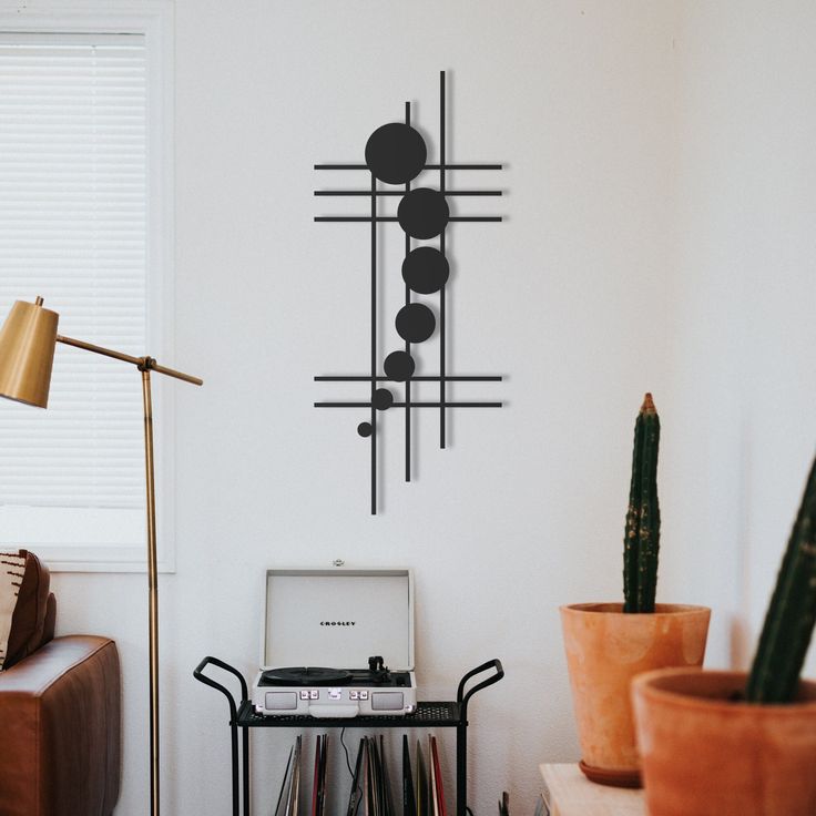 a record player sitting on top of a table in front of a wall mounted clock