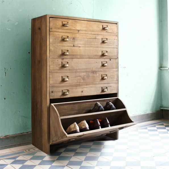 an old dresser with shoes on it in a room