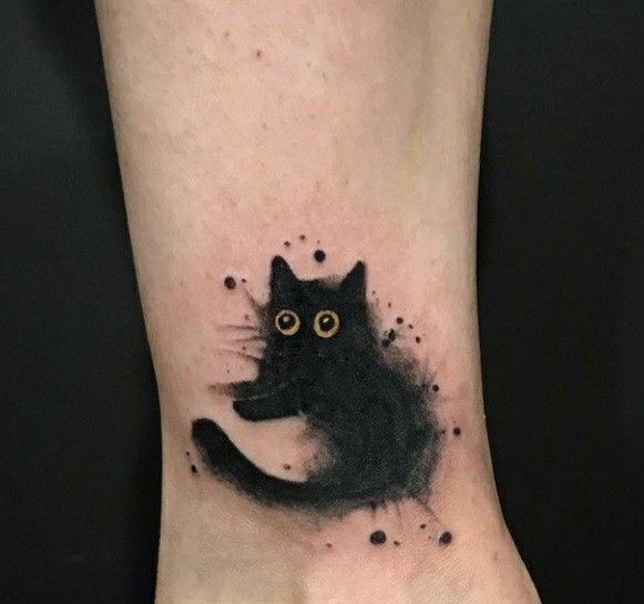 a black cat with big eyes on the foot is shown in this artistic tattoo design