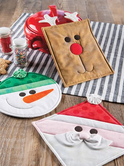 three christmas decorations on a wooden table with santa clause, snowman and mrs claus