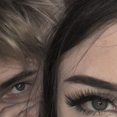 a close up of two people with long lashes and eyeliners looking at the camera