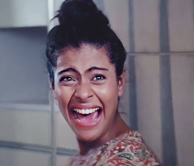 a close up of a person smiling with a tile wall behind her and the words keptt arabic on it