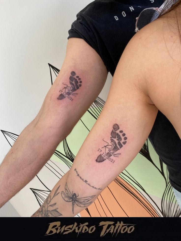 two people with matching tattoos on their arms