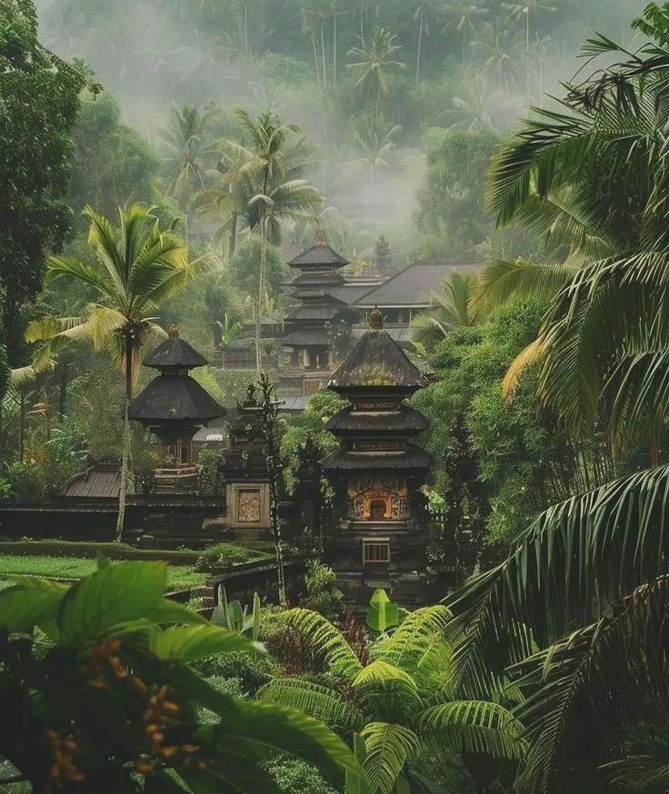 a lush green forest filled with lots of trees and buildings in the middle of it