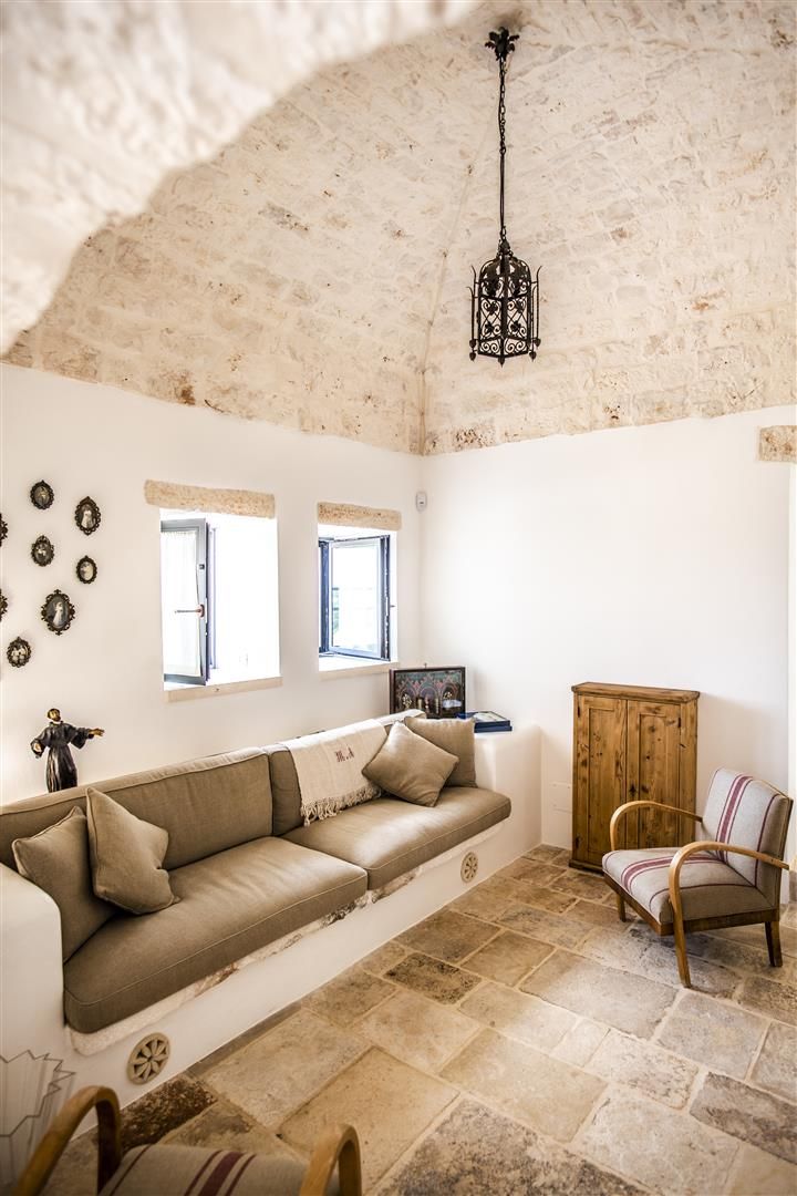 a living room filled with furniture and windows