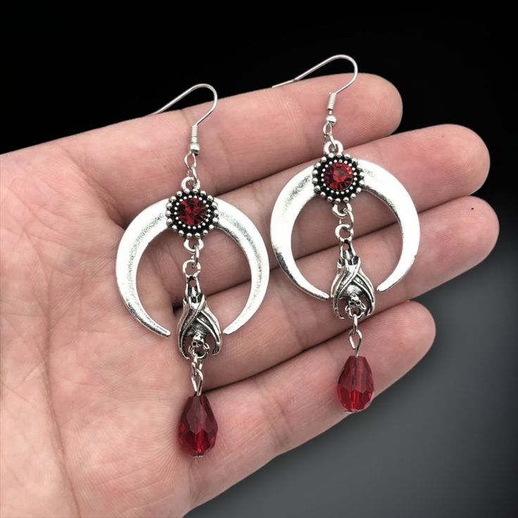 Embrace the dark allure with our Gothic Crescent Moon Earrings, featuring enchanting bats and a shimmering crystal. 🖤  These earrings are perfect for those who love to express their unique gothic style. 🌙  Crafted with care, they add an edge of mystery and elegance to any outfit. 🦇  Whether you're looking to elevate your daily accessories or make a statement at a special event, these bat-themed earrings are a must-have. ✨  Ideal for lovers of witchy and gothic fashion, they also make the perf Daily Accessories, Crescent Moon Earrings, Gothic Accessories, Witchy Jewelry, Dark Gothic, Earrings Unique, Gothic Style, Moon Earrings, Gothic Jewelry