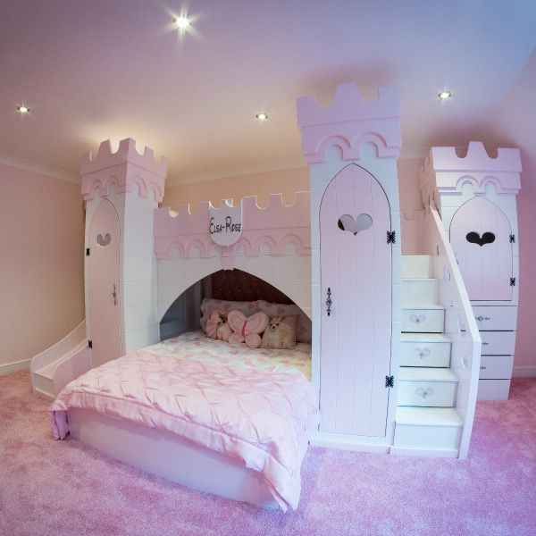 a princess bedroom with pink carpet and white furniture, stairs leading up to the bed