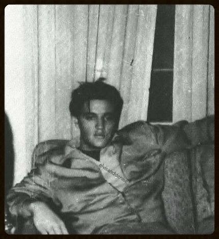 black and white photograph of two men sitting on a couch