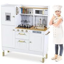 a woman standing next to a toy kitchen