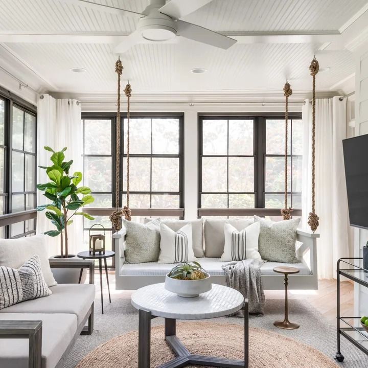 a living room filled with furniture and a flat screen tv