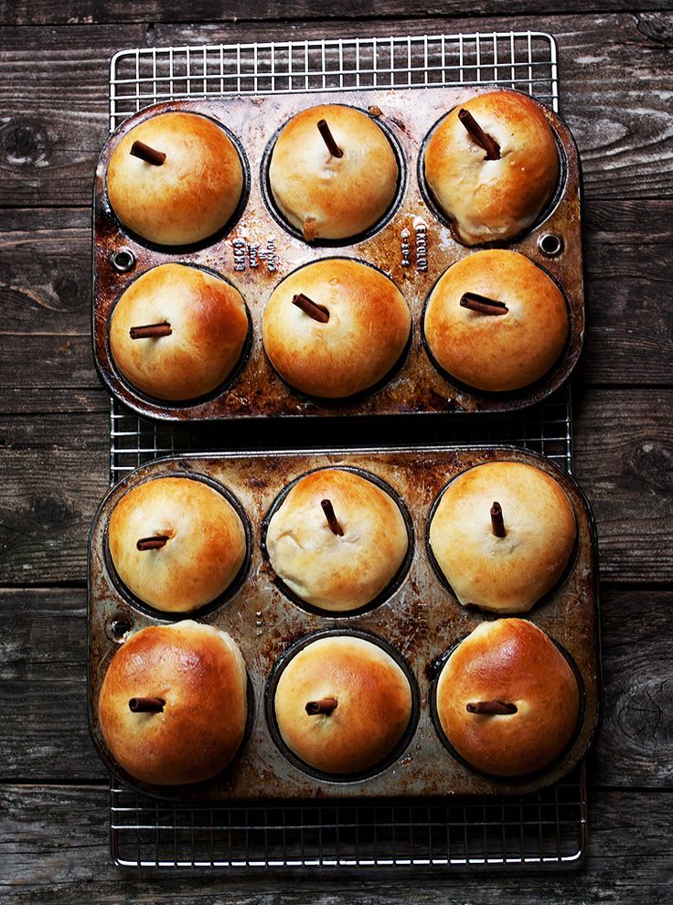 two trays filled with muffins sitting on top of a wooden table