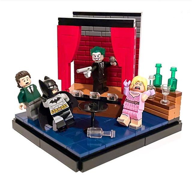 the lego batman movie scene is set up on a table with two women and one man