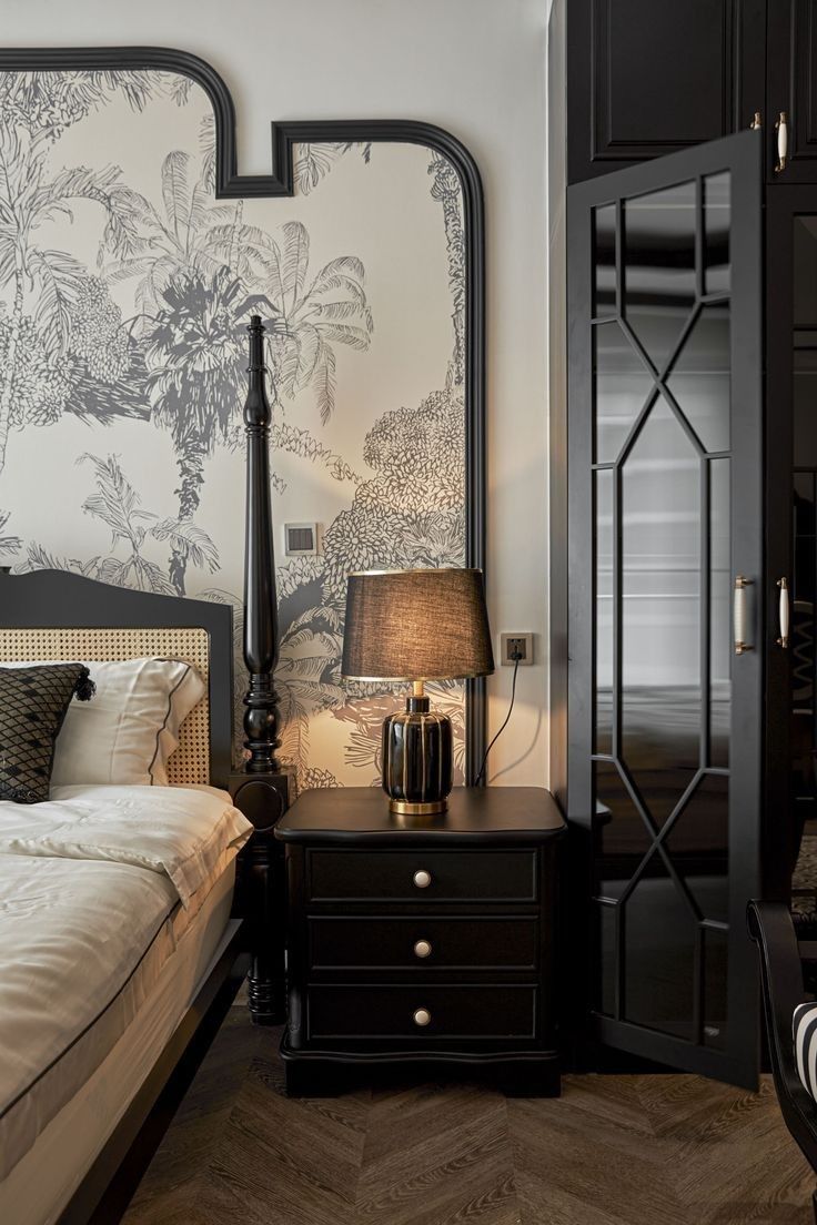 a bed room with a neatly made bed next to a night stand and two lamps