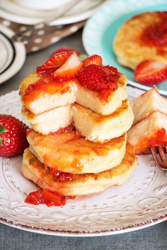 a stack of pancakes with strawberries on top