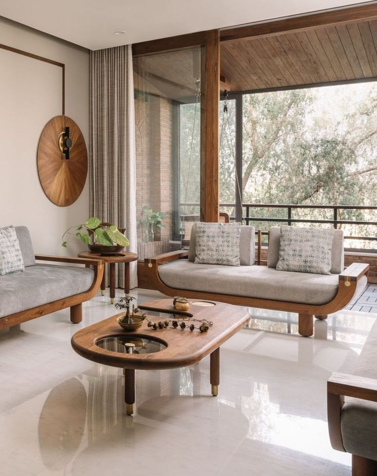 a living room with two couches and a coffee table in front of a large window