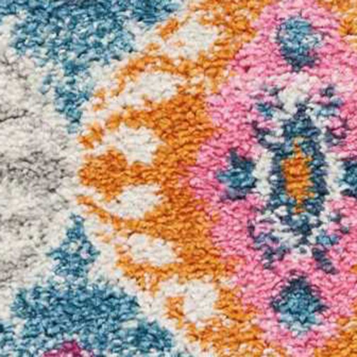 an area rug with various colors and designs on it, including blue, pink, yellow, orange, and white