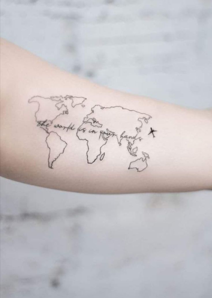 a woman's arm with a world map tattoo on the left side of her arm