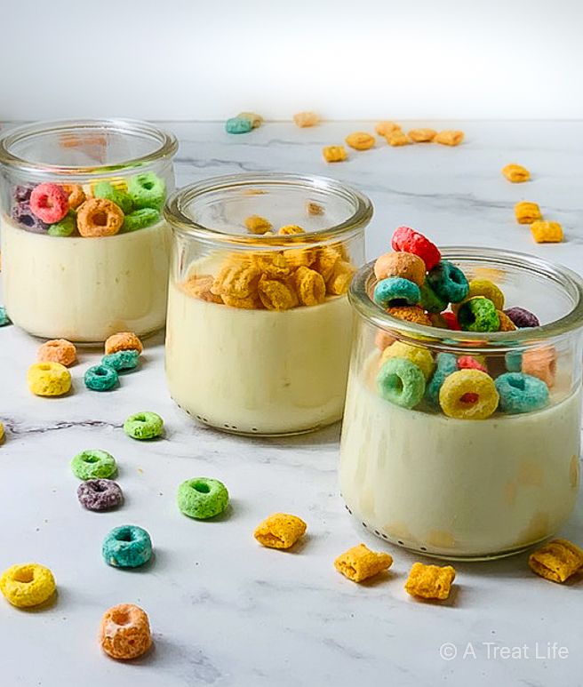 three jars filled with cereal sitting on top of a table