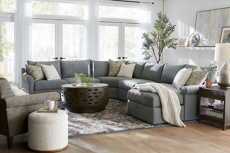 a living room filled with furniture and lots of windows