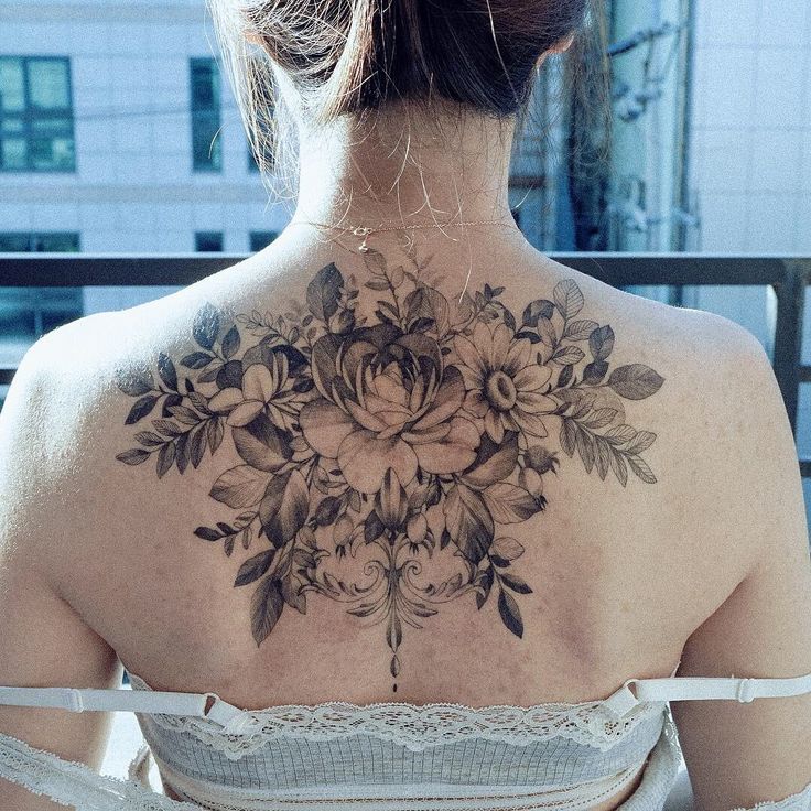 a woman with a flower tattoo on her back