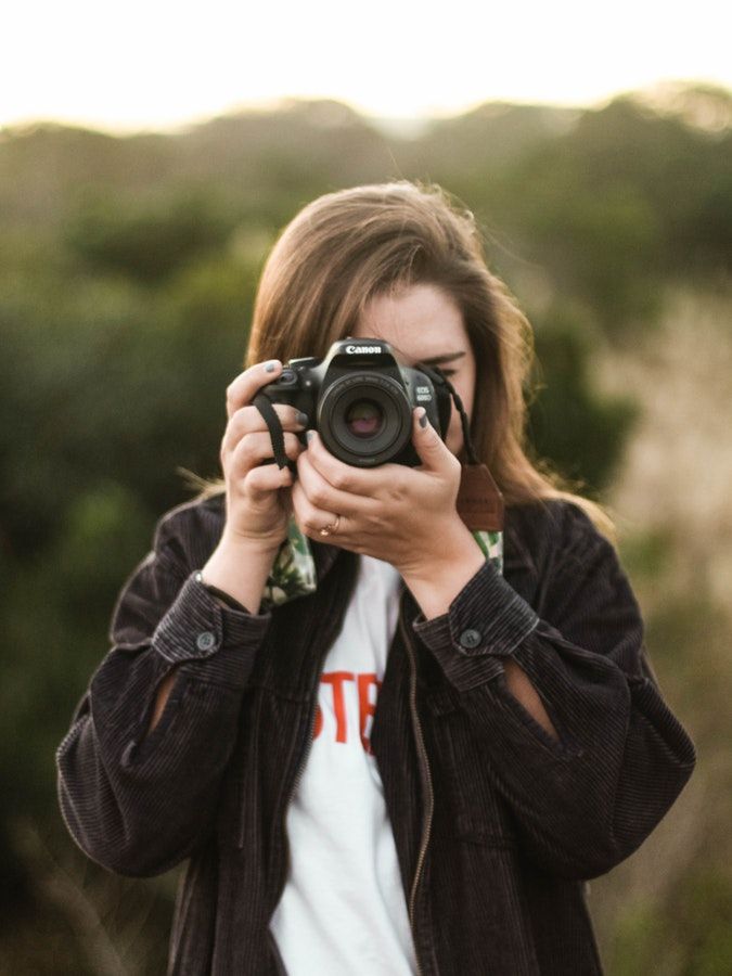 a woman taking a photo with her camera