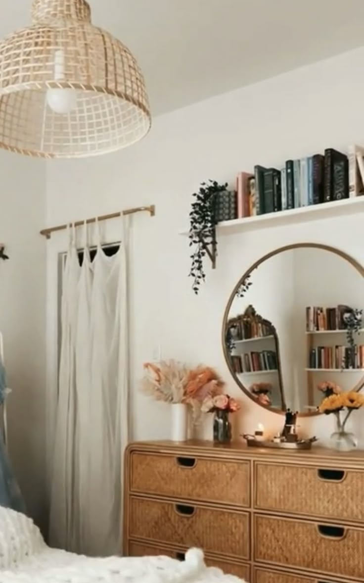 a bedroom with a dresser, mirror and bookshelf on the wall above it