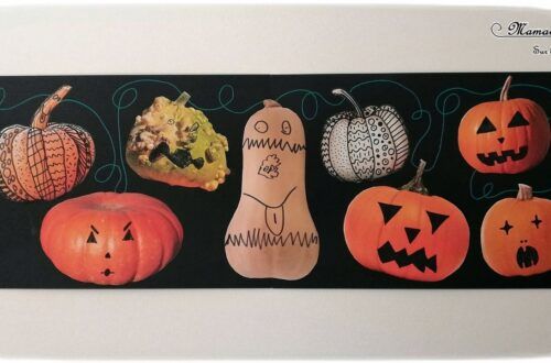 a group of carved pumpkins sitting on top of a black tablecloth covered wall