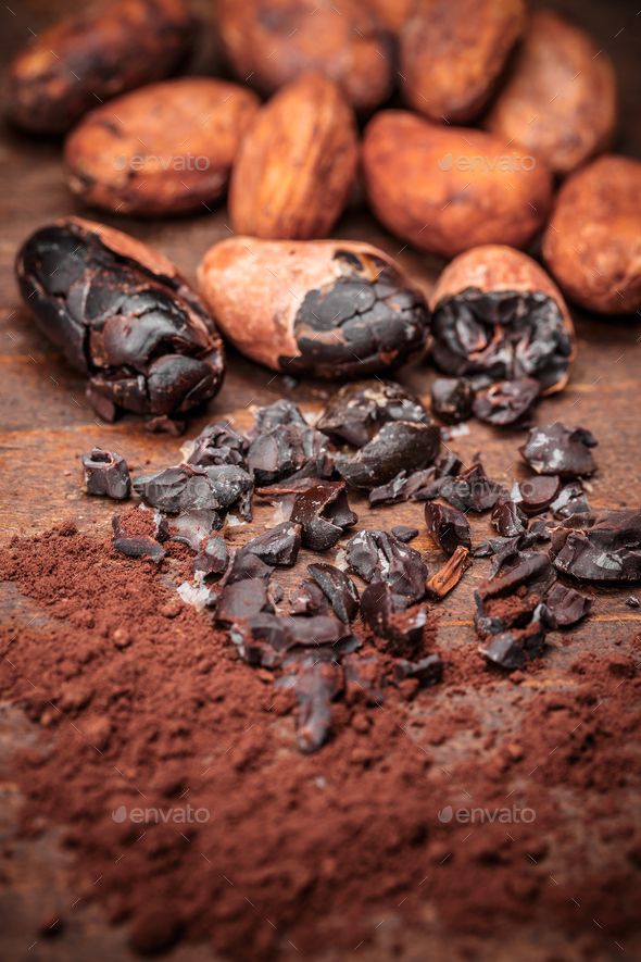 cocoa beans and chocolate chips on a wooden table