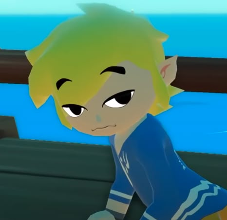 a cartoon boy with green hair and blue shirt