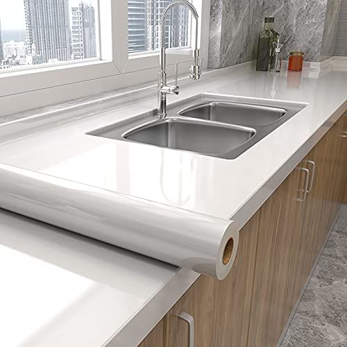 a kitchen counter top with a sink and window in the backgrounnd area