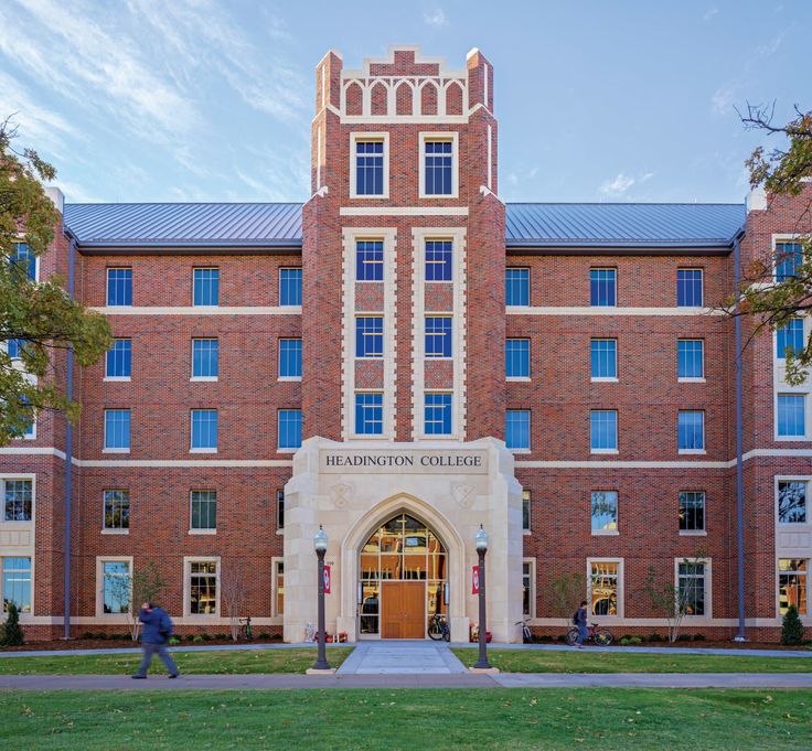 a large brick building with a clock tower on it's front and side entrance