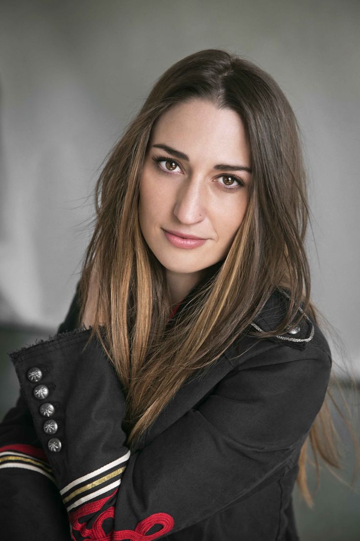 a woman with long hair wearing a black jacket