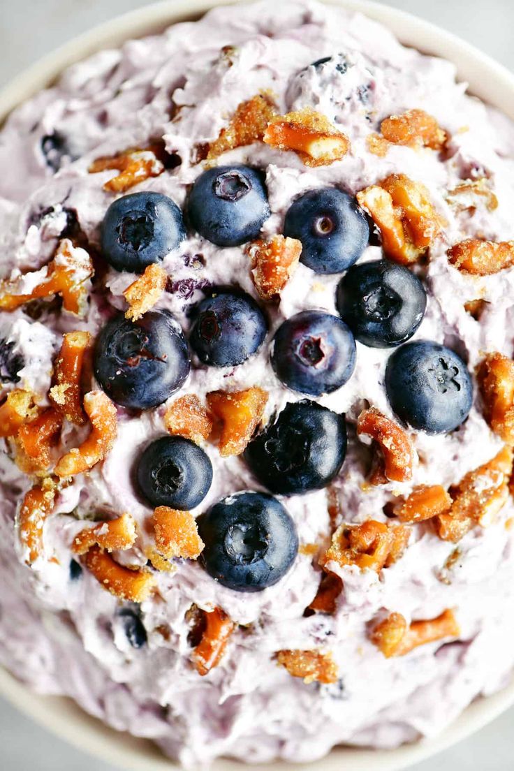 a bowl filled with blueberries and granola