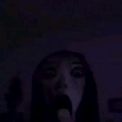 a woman with her mouth open in the dark