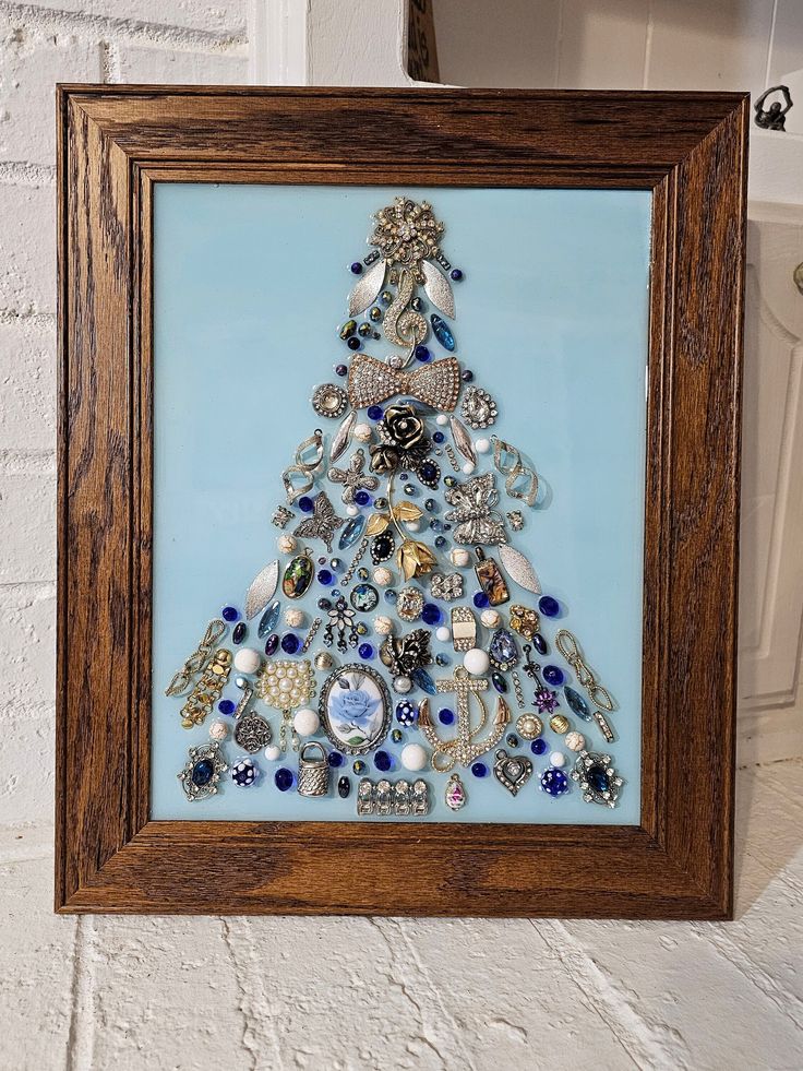 a christmas tree made out of buttons in a wooden frame