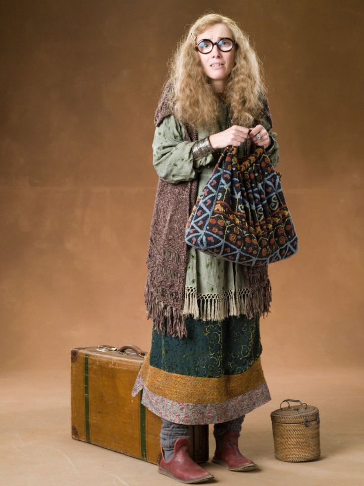 a woman standing next to a suitcase with information about her clothing and name on it