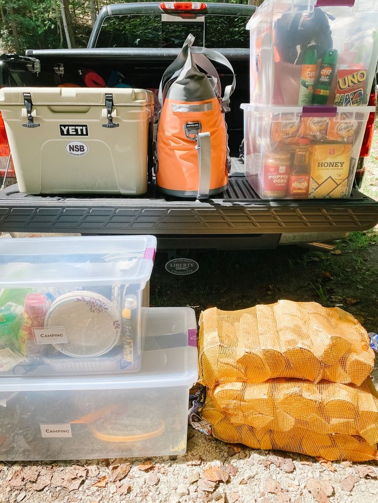 the back end of a truck filled with coolers and other things to pack in