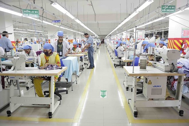 an assembly line with workers working on sewing machines