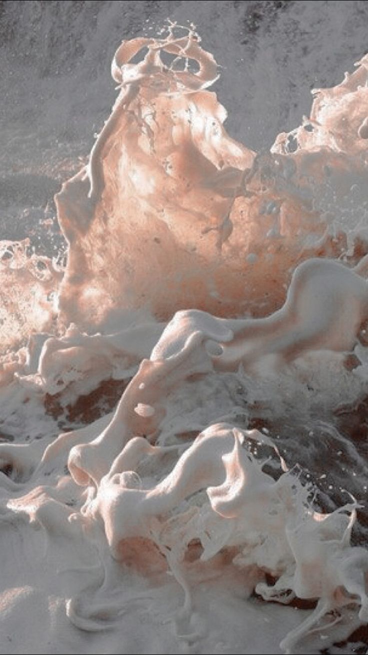 an ocean wave with white foam on it