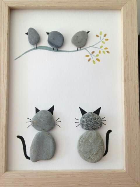 two cats sitting next to each other on top of a white framed wall with birds perched on the branch