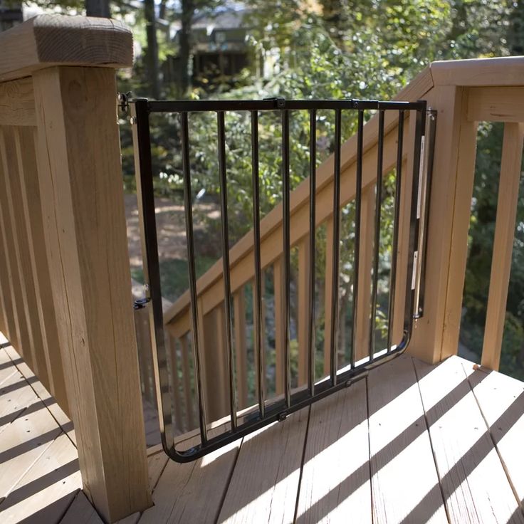 a wooden deck with railings and flowers in the foreground on a sunny day