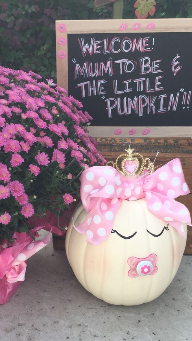 a pumpkin with a crown on it sitting next to flowers and a sign that says, welcome mum to be the little pumpkin