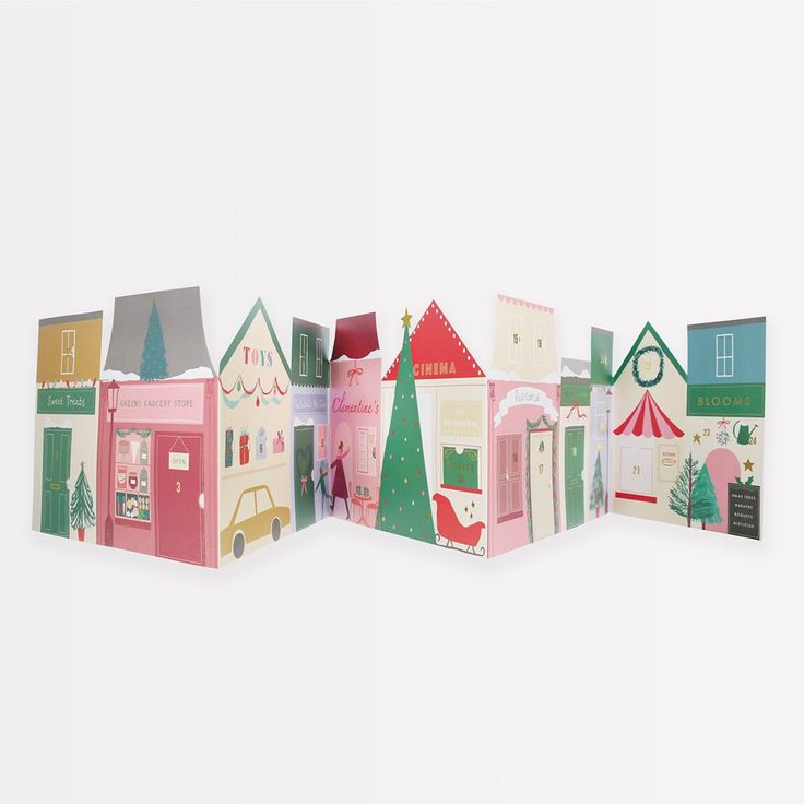 an assortment of paper houses are arranged in a row