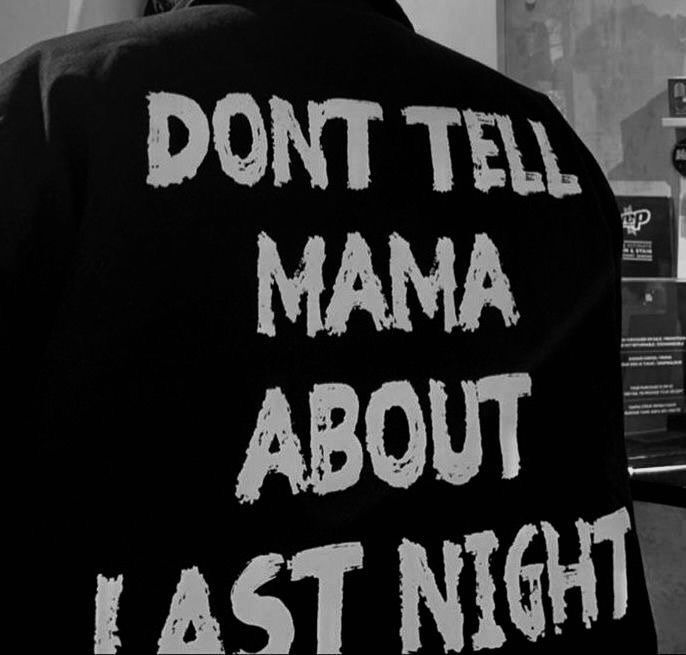 a man wearing a jacket that says, don't tell mama about last night