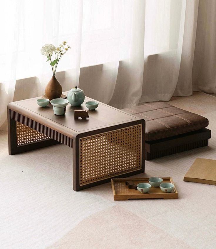 a living room scene with focus on the coffee table and trays that have tea cups on them