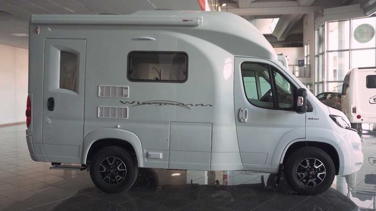 a white camper van parked in a building