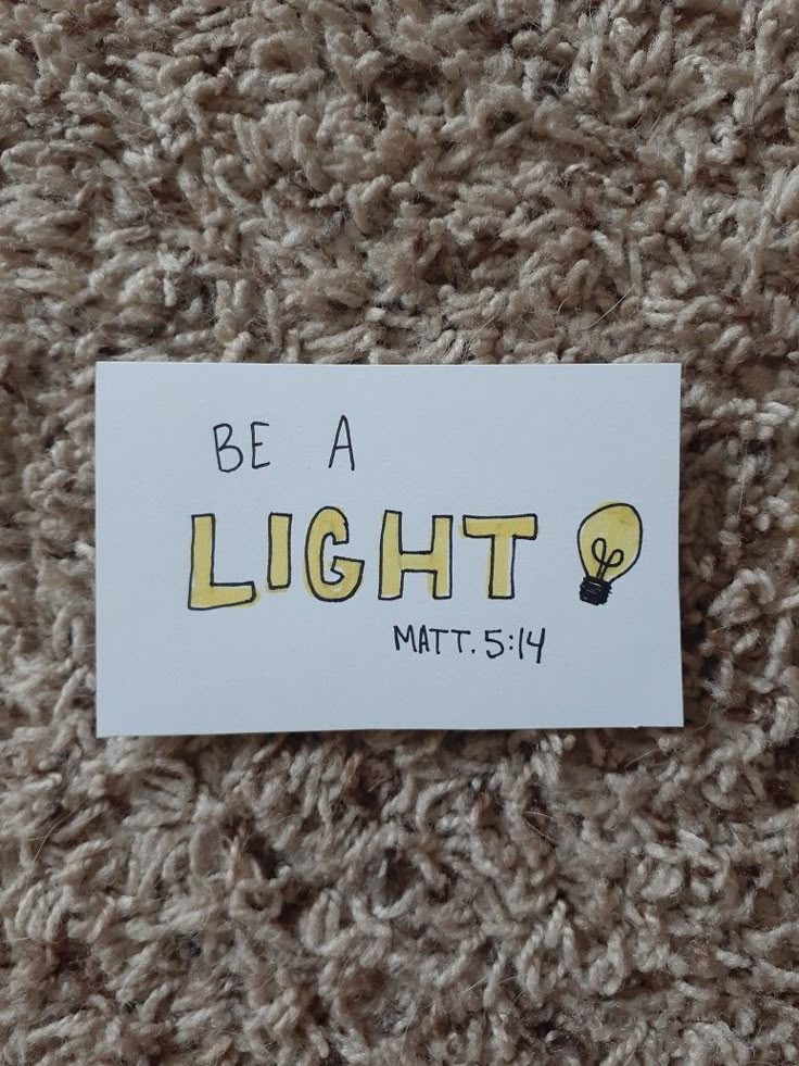 a piece of paper with the words be a light on it