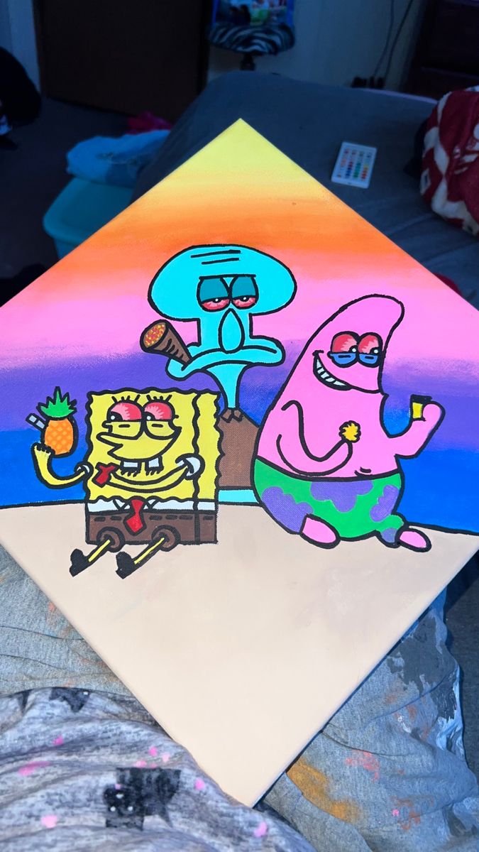 this is an image of spongebob and patrick painting on a piece of paper